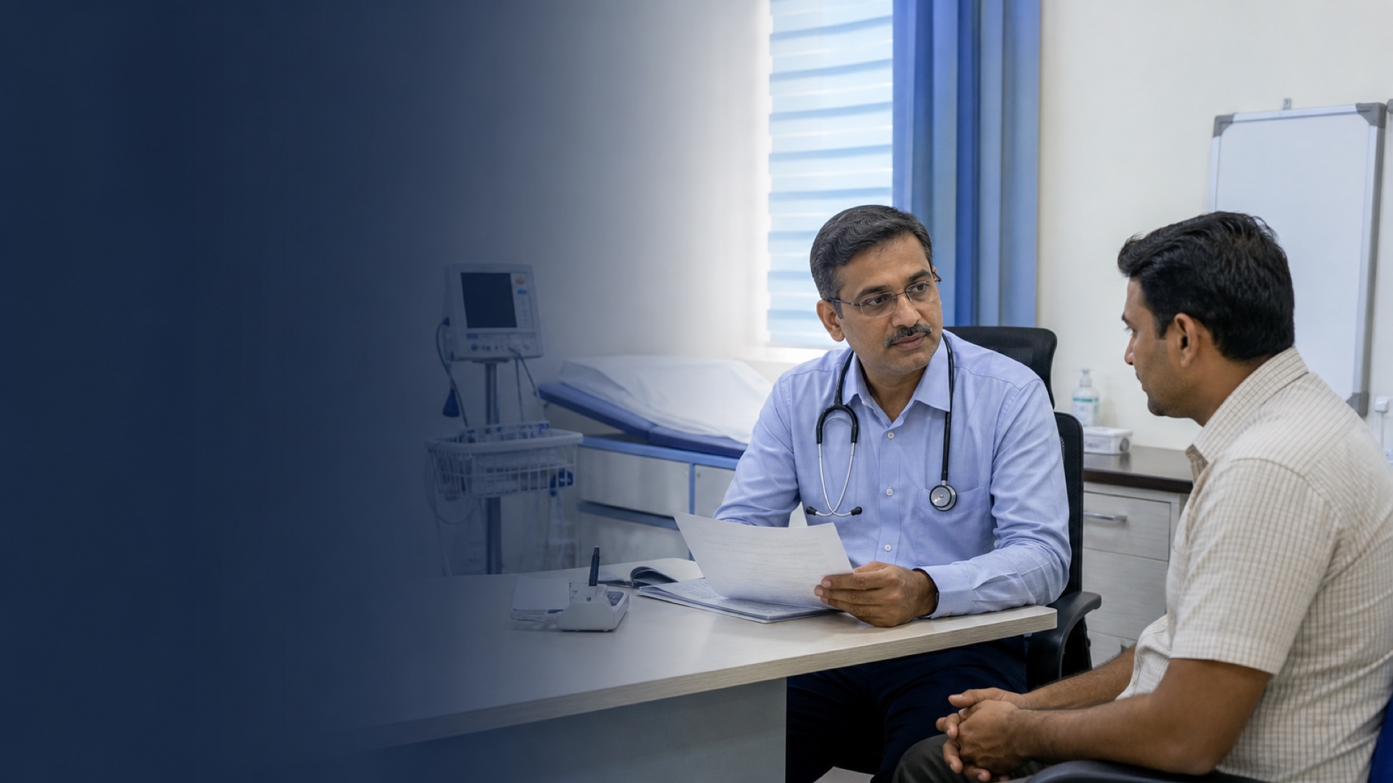 General physician reviewing a medical report with a patient at Mangala Hospital